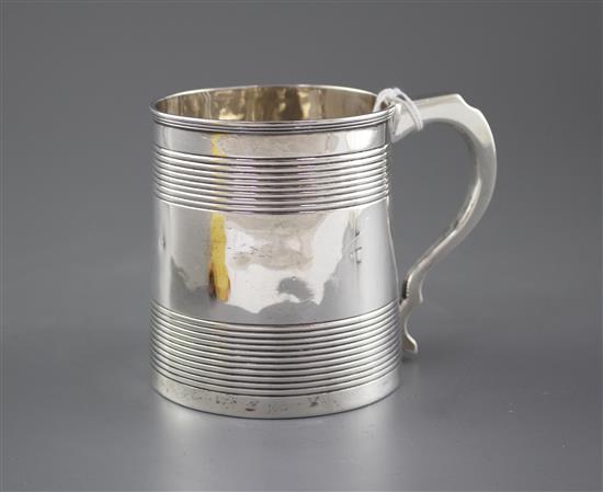 A Georgian reeded silver mug, (marks rubbed and top of handle is repaired), height 96mm, 8.5oz.